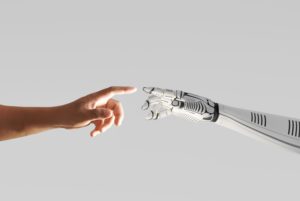 A ROBOT HAND AND HUMAN HAND TOUCH
