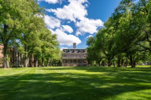 A GRAND, NEO-CLASSICAL BUILDING SITS AT THE END OF A LONG, MANICURED, TREE-LINED LAWNUNIVERSITY OF NEVADA iStock-Wirestock-1446194896.jpg